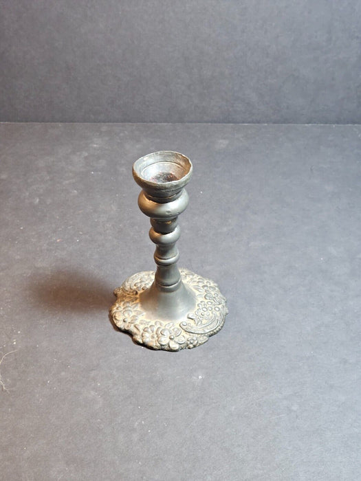 5" high cast pewter candlestick ,unmarked,floral design. Heavy 20 oz.