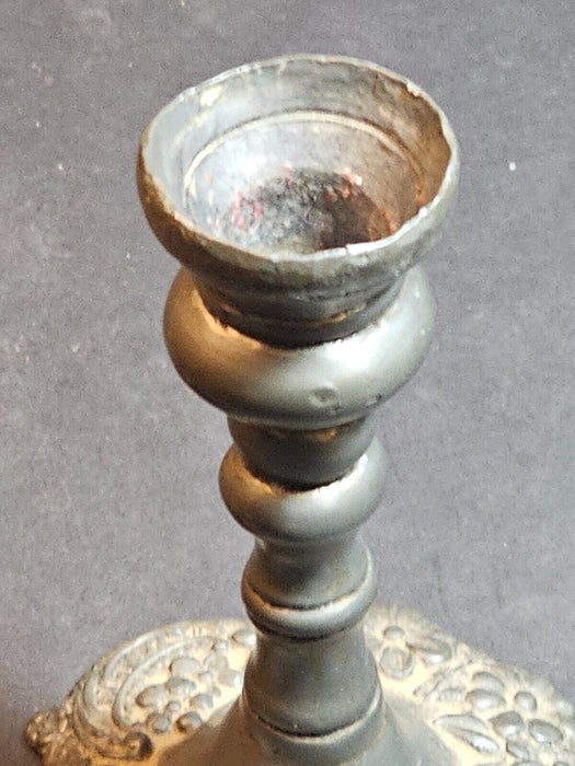 5" high cast pewter candlestick ,unmarked,floral design. Heavy 20 oz.