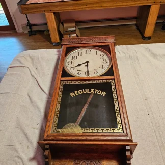 Ingraham regulator clock/36 x16 x5/time only/pen and key/ sat for 20 yrs.