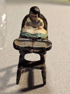 3.5"cast iron high chair with cast iron doll for under christmas tree 1930s