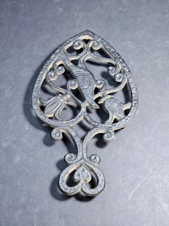 Trivet heart shaped with bird 8" in length excellent