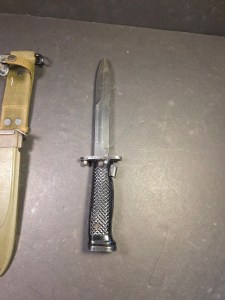 A genuine Milpar Co. M7 bayonet and M8A1 scabbard. This collectible piece of military history is a perfect addition for any enthusiast or collector of Vietnam War-era militaria. A classic and authentic find.