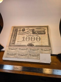 Confederate bond, showing the $1000 denomination and text. Caption: A detailed view of the central section of the bond, highlighting the official text and design.