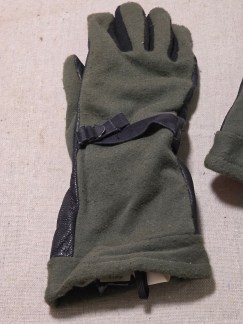 Group lot featuring a pair of US military GORE-TEX cold weather gloves in OD green and a tan leather and green webbing helmet suspension harness.