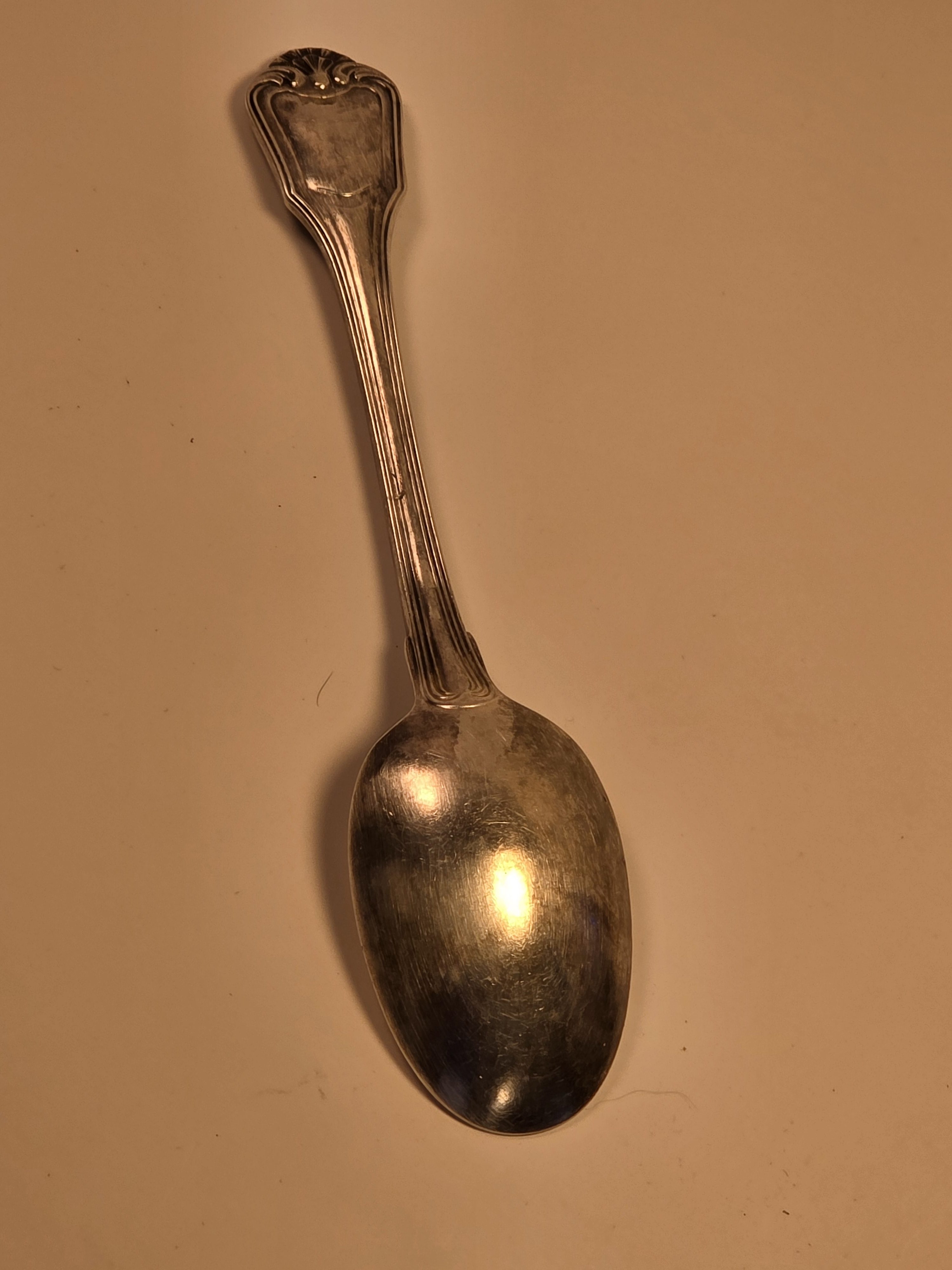 Single Christofle Malmaison silver-plated spoon showing the back of the bowl with hallmarks and the handle with the Iraqi Eagle crest.