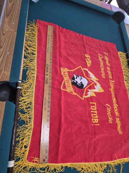 A ceremonial Russian Scout flag featuring a gold Fleur-de-lis and Russian Cyrillic text on a traditional tri-color background.