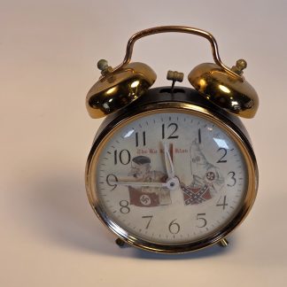 mid-20th-century novelty alarm clock illustrating the era's use of controversial and offensive political imagery.