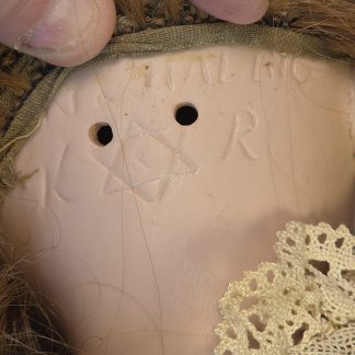 Close up of Simon & Halbig and Kammer & Reinhardt K R Star markings on antique doll.